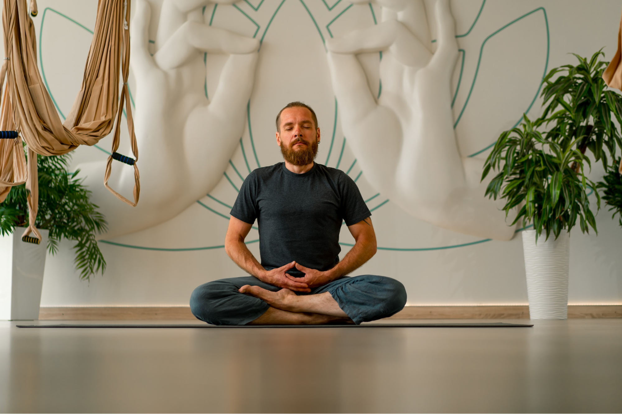 A man sitting on the floor while meditating.